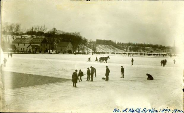 Workers cutting ice from the frozen Milwaukee River upstream of the North Avenue bridge in the winter of 1899-1900. The horse in the background is cutting grooves in the ice in an exact grid. Workers break off the ice and load it into one of seven huge Icehouses located between the North Avenue dam and the foot of East Chambers Street. Courtesy Milwaukee Public Library/Historic Photo Collection